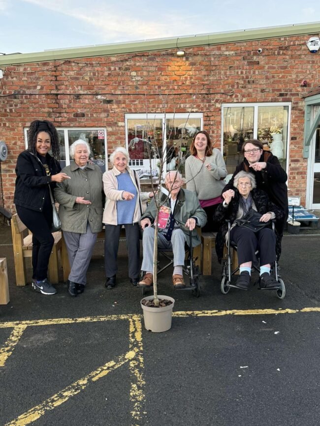 York Manor residents and staff planting an apple tree at Thirsk Garden Centre